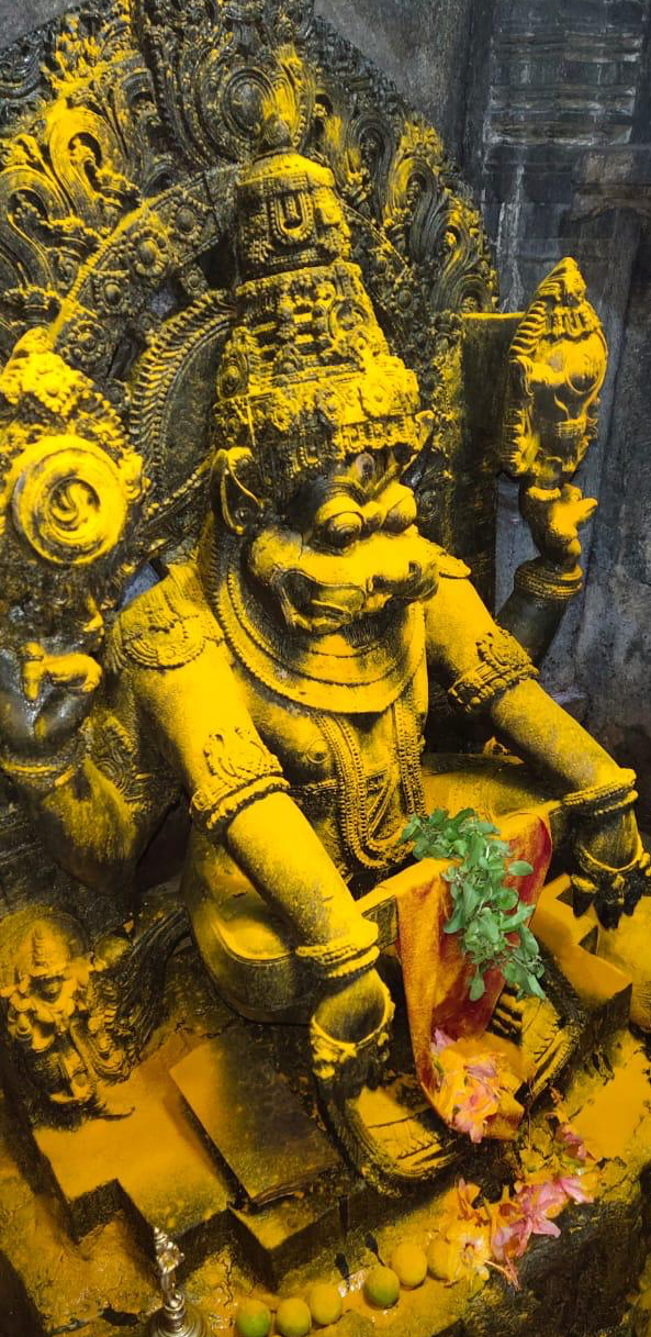 Yoga Narasimha anointed with turmeric, seated in the sanctum