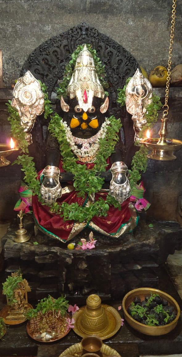 Yoga Narasimha decorated with silver ornaments and garlands